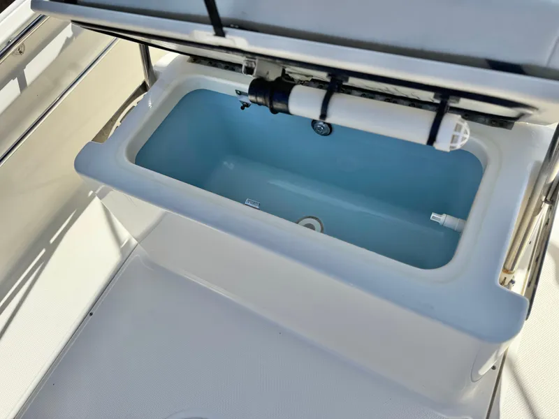 Slide: The Image of Livewell on 2021 Boston Whaler 170 Montauk boat, open lid, white and blue interior. - 21