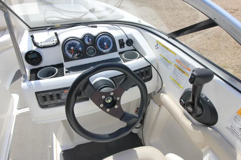Slide: The Image of 2013 Bayliner 190 Deck Boat dashboard with steering wheel and control panel. - 15