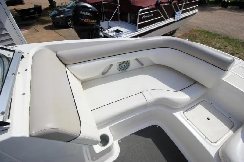 Slide: The Image of 2013 Bayliner 190 Deck Boat interior seating with white cushioned upholstery. - 20