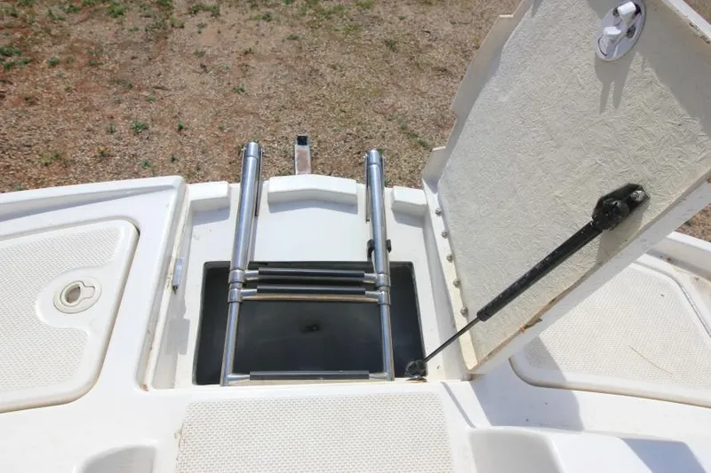 Slide: The Image of 2013 Bayliner 190 Deck Boat with foldable swim ladder and storage compartment. - 23