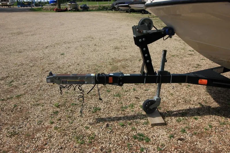 Slide: The Image of 2013 Bayliner 190 Deck Boat trailer hitch on gravel lot. - 4