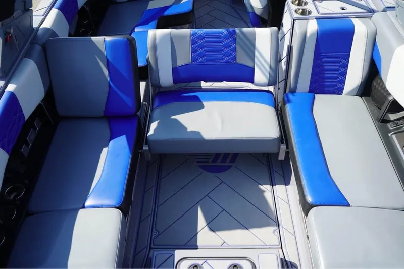 Slide: The Image of 2022 Malibu Wakesetter 25 LSV interior with blue and gray seating arrangement. - 11
