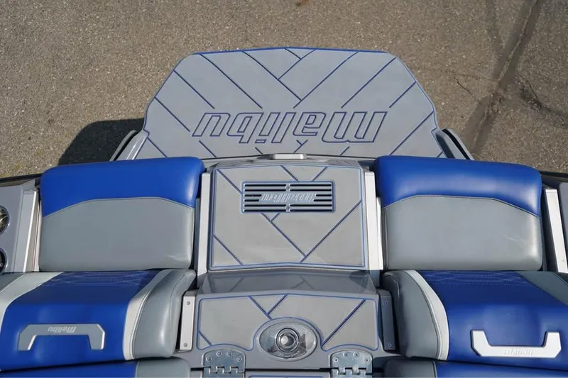 Slide: The Image of 2022 Malibu Wakesetter 25 LSV boat interior with blue and gray seating. - 13