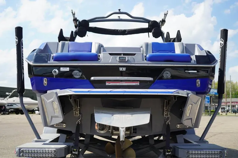 Slide: The Image of 2022 Malibu Wakesetter 25 LSV boat rear view with blue seating and sleek design. - 14