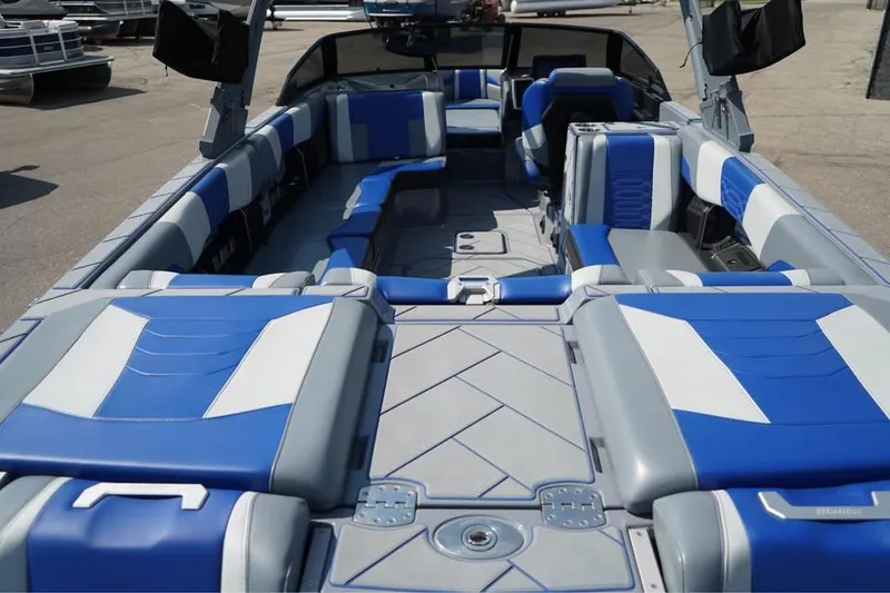 Slide: The Image of 2022 Malibu Wakesetter 25 LSV interior with blue and gray seating, spacious layout. - 16