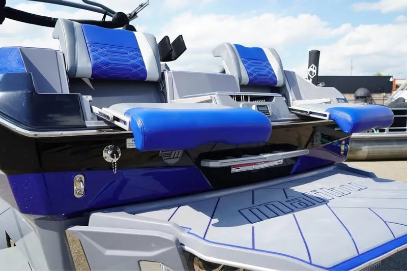 Slide: The Image of 2022 Malibu Wakesetter 25 LSV boat with blue and gray seating and sleek design. - 17