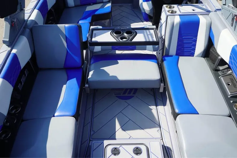 Slide: The Image of 2022 Malibu Wakesetter 25 LSV interior with blue and gray seating, cup holders, and modern design. - 3