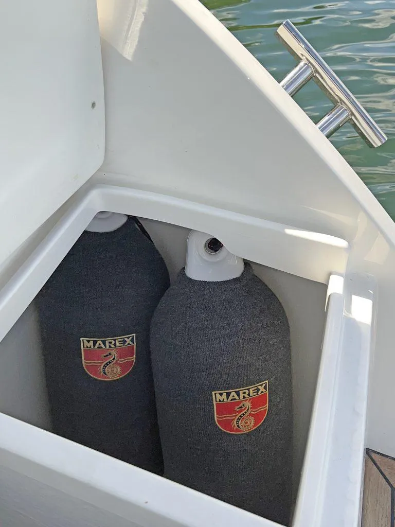 Slide: The Image of Storage compartment on 2025 Marex 310 Sun Cruiser with Marex-branded fenders. - 23