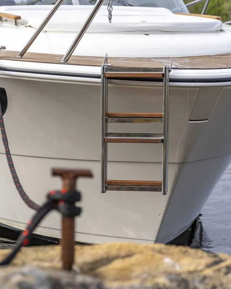 Slide: The Image of 2025 Marex 310 Sun Cruiser with ladder, docked by the water. - 25