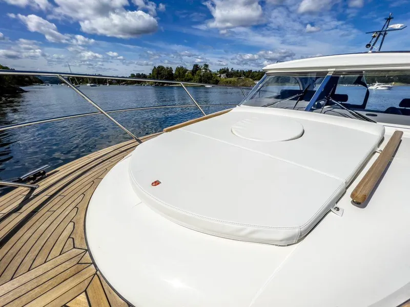 Slide: The Image of 2025 Marex 310 Sun Cruiser on calm water, featuring sleek deck design and clear skies. - 29