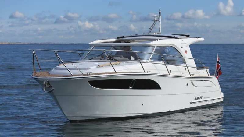 Slide: The Image of 2025 Marex 310 Sun Cruiser yacht on calm sea under blue sky. - 31