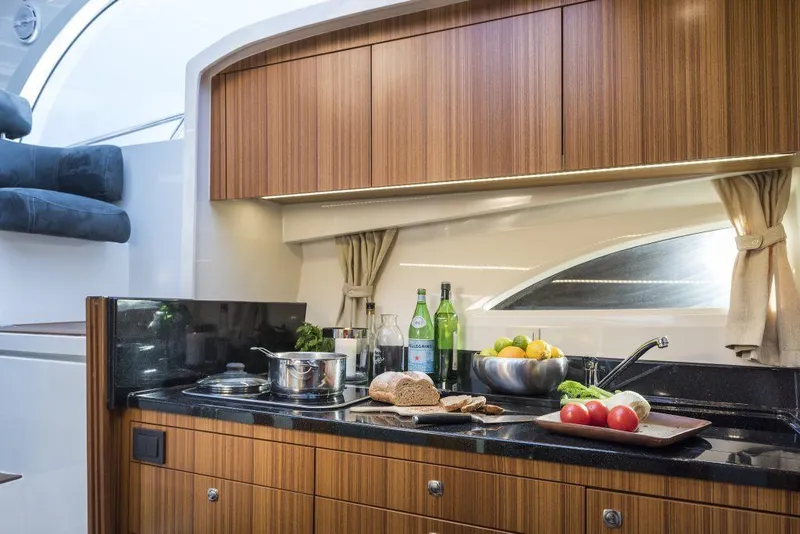 Slide: The Image of Modern kitchen interior of 2025 Marex 310 Sun Cruiser yacht with wooden cabinets and countertop. - 41
