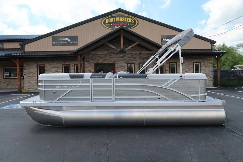 Slide: The Image of 2025 Bennington S L-Bench 20 SL pontoon boat outside dealership. - 0