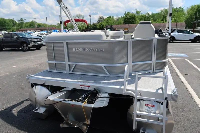 Slide: The Image of 2025 Bennington S L-Bench 20 SL pontoon boat in a parking lot. - 14