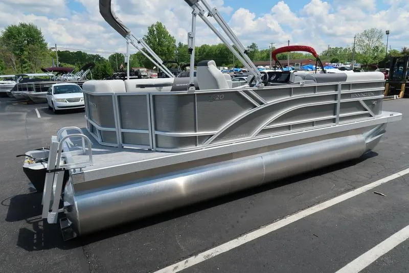 Slide: The Image of 2025 Bennington S L-Bench 20 SL pontoon boat in parking lot, side view. - 15