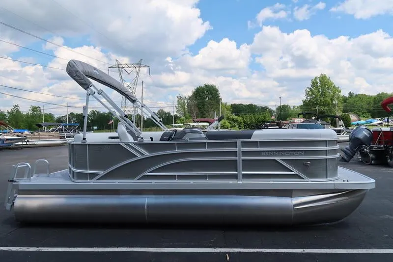 Slide: The Image of 2025 Bennington S L-Bench 20 SL pontoon boat in a parking lot. - 16