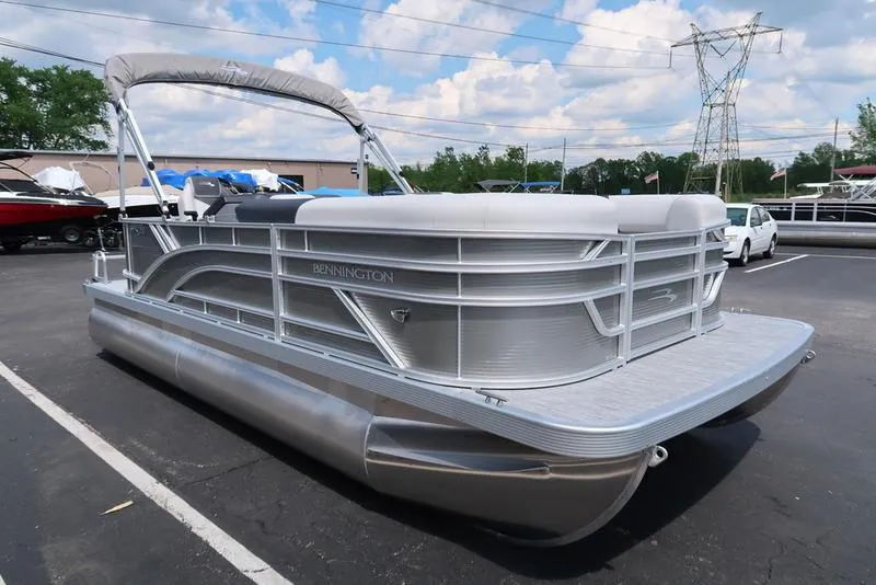 Slide: The Image of 2025 Bennington S L-Bench 20 SL pontoon boat in a parking lot. - 17
