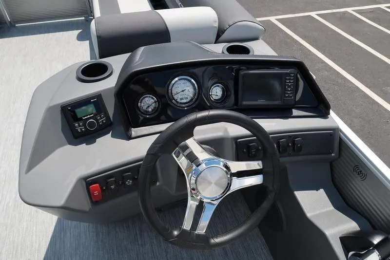 Slide: The Image of 2025 Bennington S L-Bench 20 SL boat dashboard with steering wheel and gauges. - 3