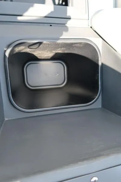 Slide: The Image of 2025 Bennington S L-Bench 20 SL storage compartment, gray interior detail. - 8