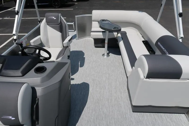 Slide: The Image of 2025 Bennington S L-Bench 20 SL pontoon boat interior with gray seating and steering console. - 9