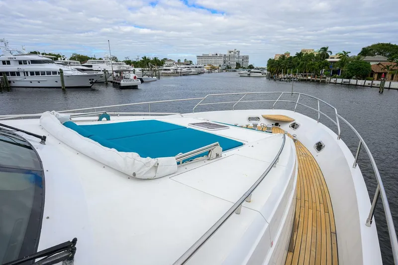 Slide: The Image of Luxury Princess 95 yacht deck, 2009 model, docked in a marina with scenic waterfront views. - 12