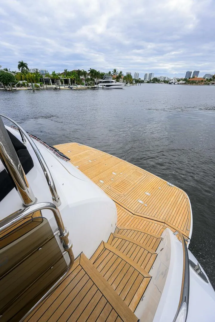 Slide: The Image of Luxury yacht Princess 95, 2009 model, with wooden deck on a serene waterfront. - 15