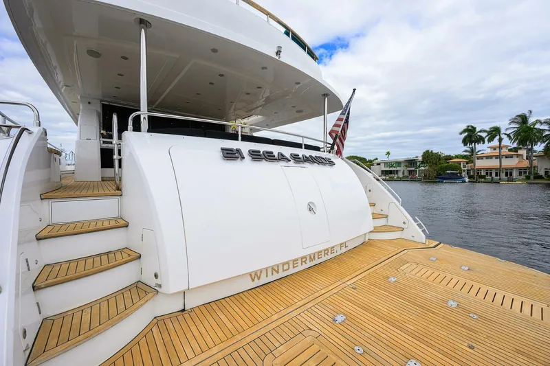 Slide: The Image of Luxury yacht Princess 95, 2009 model, docked with wooden deck and scenic waterfront view. - 16