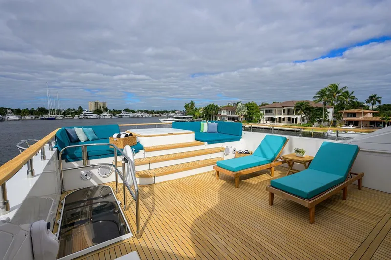 Slide: The Image of Luxurious 2009 Princess 95 yacht deck with turquoise loungers and scenic waterfront view. - 20