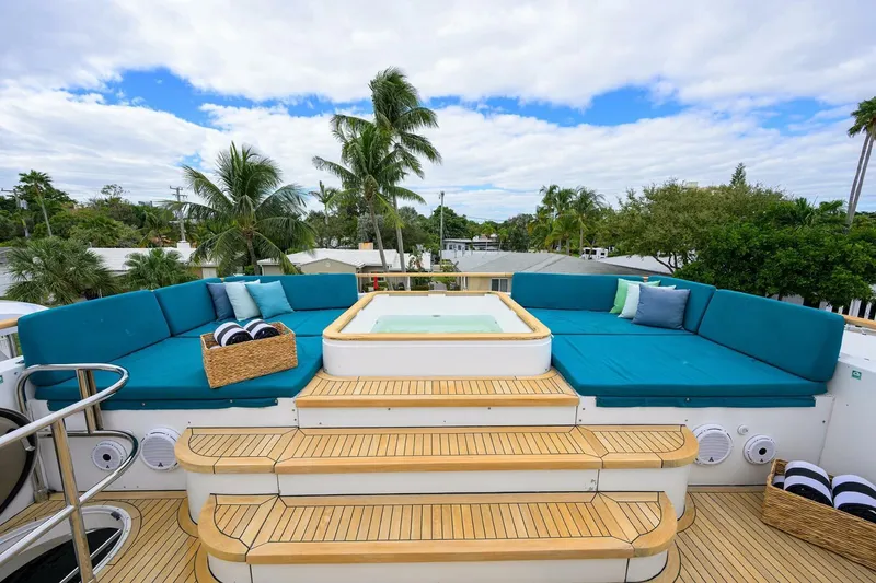 Slide: The Image of Luxurious 2009 Princess 95 yacht deck with jacuzzi, surrounded by plush seating and tropical scenery. - 21