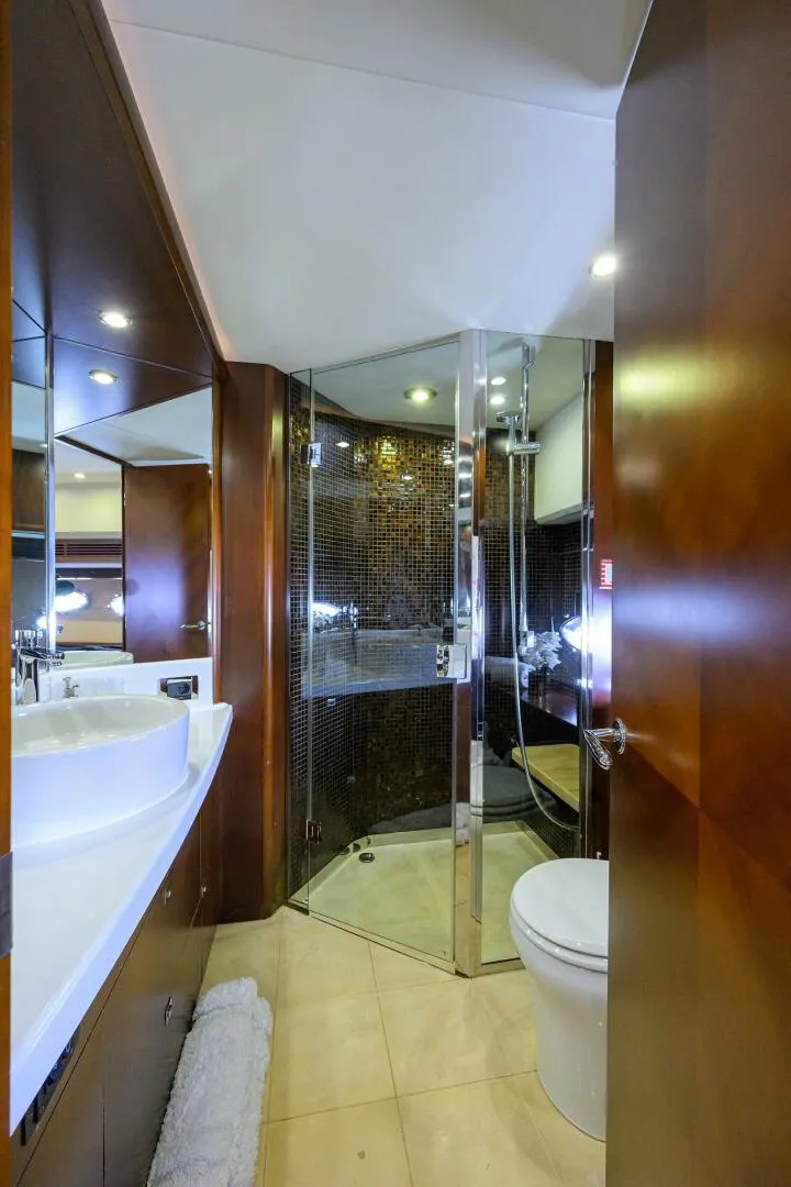Slide: The Image of Luxurious yacht bathroom with modern shower, elegant fixtures, and wood accents, Princess 95, 2009 model. - 46