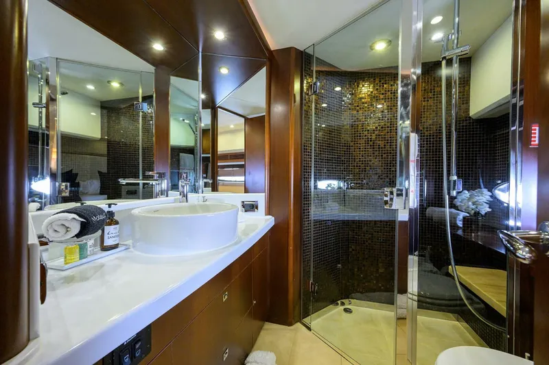 Slide: The Image of Luxurious yacht bathroom with modern fixtures, glass shower, and elegant wood accents, Princess 95, 2009. - 47