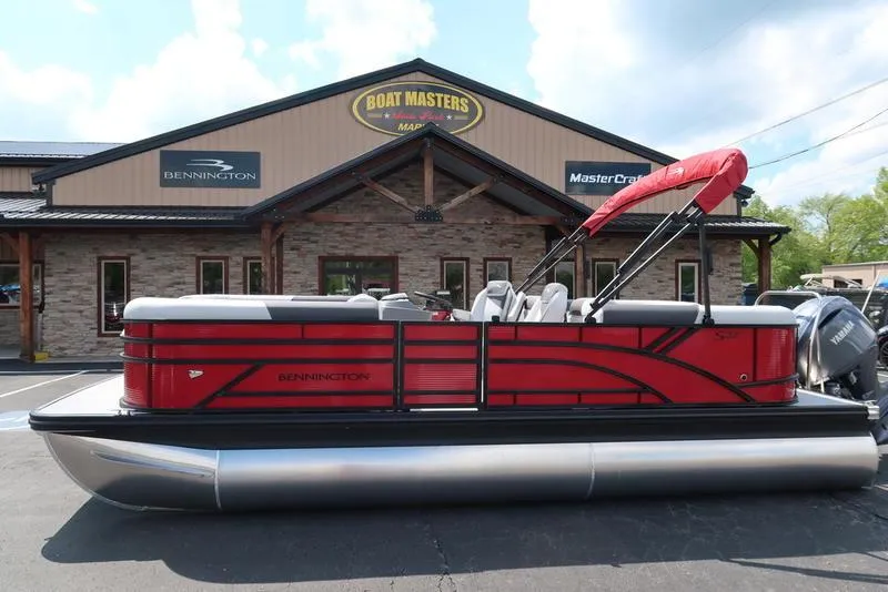 Slide: The Image of 2025 Bennington S Quad Bench 22 SSR pontoon boat in front of dealership. - 0