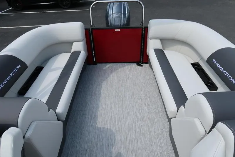 Slide: The Image of 2025 Bennington S Quad Bench 22 SSR interior with gray and white seating. - 1