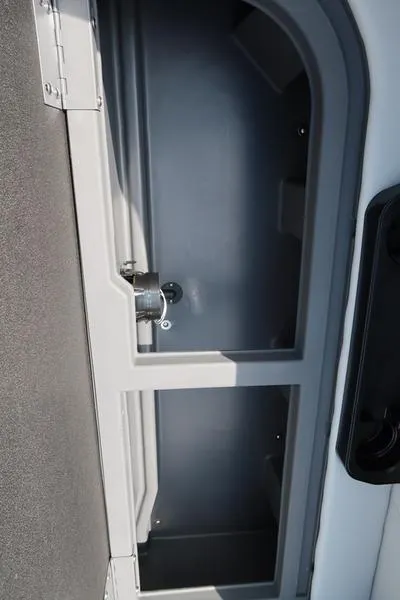 Slide: The Image of 2025 Bennington S Quad Bench 22 SSR storage compartment, open and empty. - 10