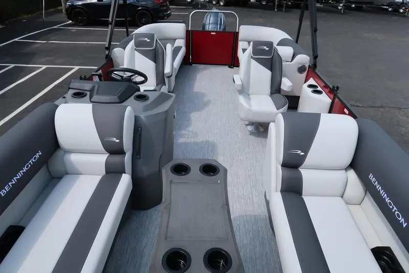 Slide: The Image of 2025 Bennington S Quad Bench 22 SSR pontoon boat interior with gray and white seating. - 12