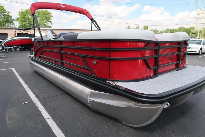 Slide: The Image of 2025 Bennington S Quad Bench 22 SSR pontoon boat with red and black design. - 17