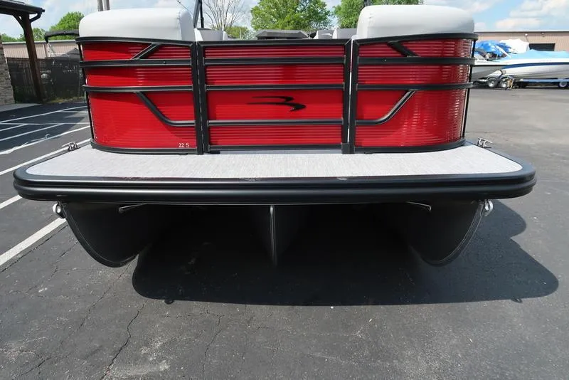 Slide: The Image of 2025 Bennington S Quad Bench 22 SSR pontoon boat, rear view, red and black design. - 19