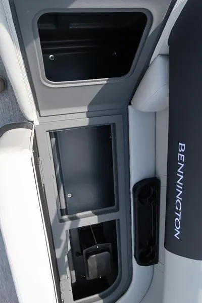 Slide: The Image of 2025 Bennington S Quad Bench 22 SSR interior storage compartments. - 22