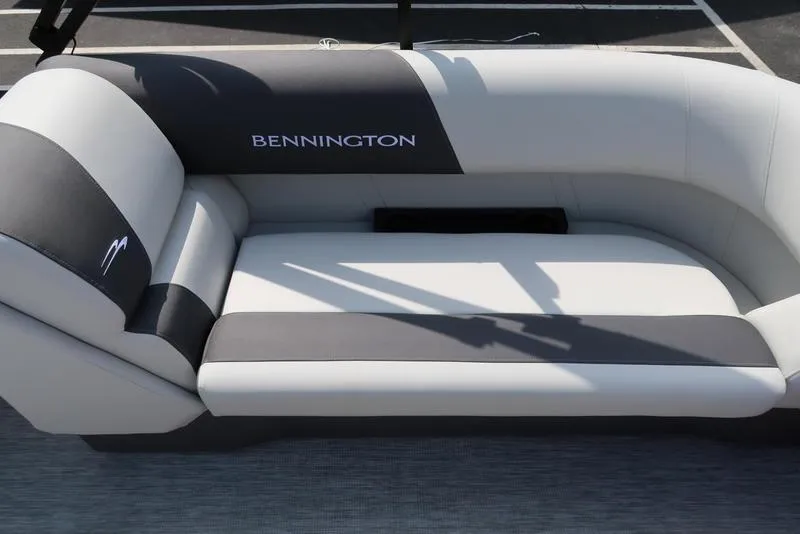 Slide: The Image of 2025 Bennington S Quad Bench 22 SSR boat seating, featuring sleek gray and black upholstery. - 23