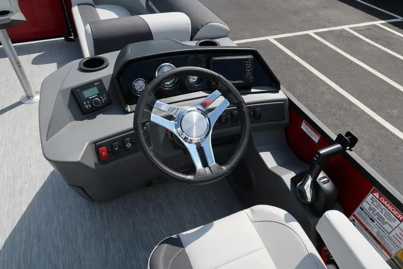 Slide: The Image of 2025 Bennington S Quad Bench 22 SSR boat dashboard with steering wheel and controls. - 6