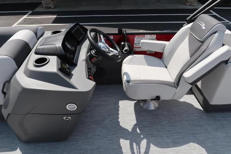 Slide: The Image of 2025 Bennington S Quad Bench 22 SSR boat interior with modern helm and seating. - 7