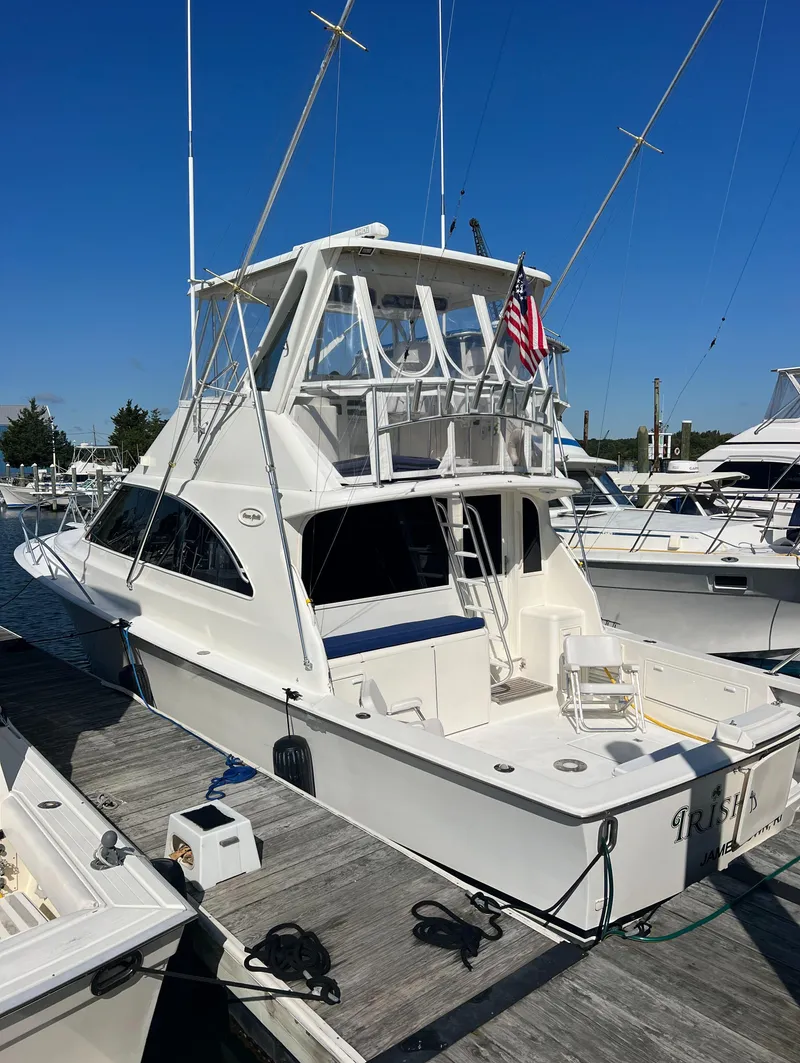 Slide: The Image of 1998 Ocean Yachts 45 Super Sport docked, featuring a spacious flybridge and sleek design. - 10