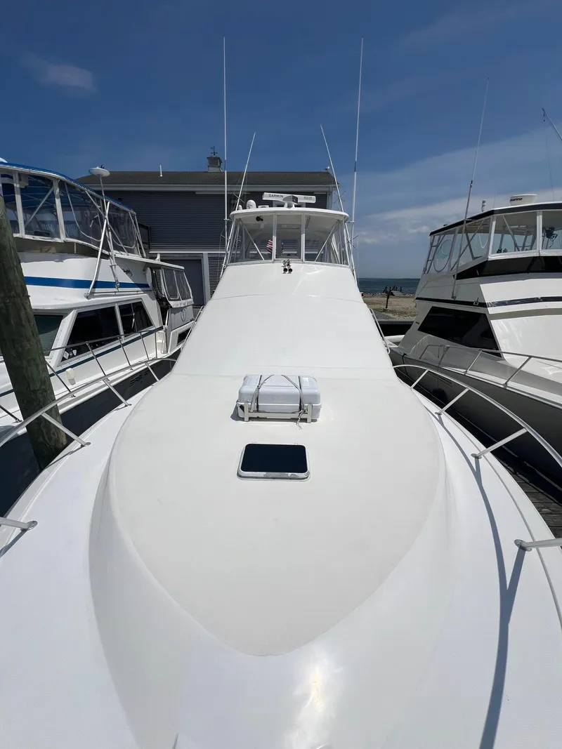 Slide: The Image of 1998 Ocean Yachts 45 Super Sport docked, showcasing sleek white deck and cabin. - 12