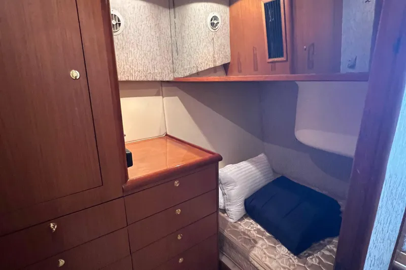 Slide: The Image of Cozy cabin interior of 1998 Ocean Yachts 45 Super Sport with wooden cabinetry and single bed. - 6