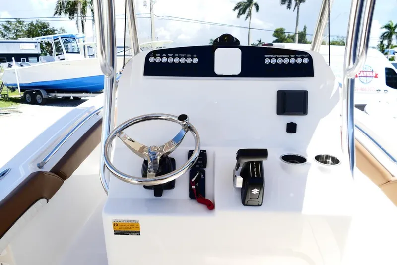 Slide: The Image of 2026 Pioneer 222 Islander boat dashboard with steering wheel and controls. - 12