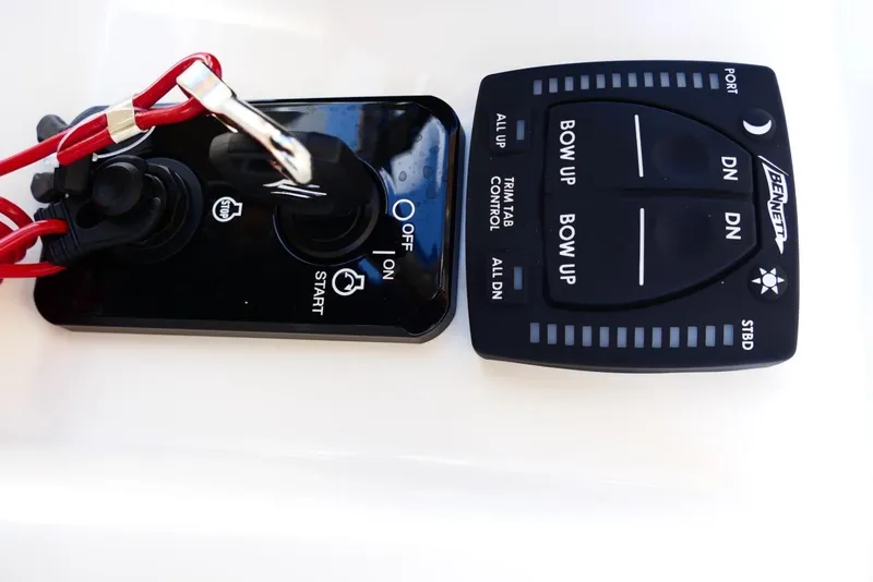 Slide: The Image of Control panel of 2026 Pioneer 222 Islander boat with ignition and trim tab controls. - 13