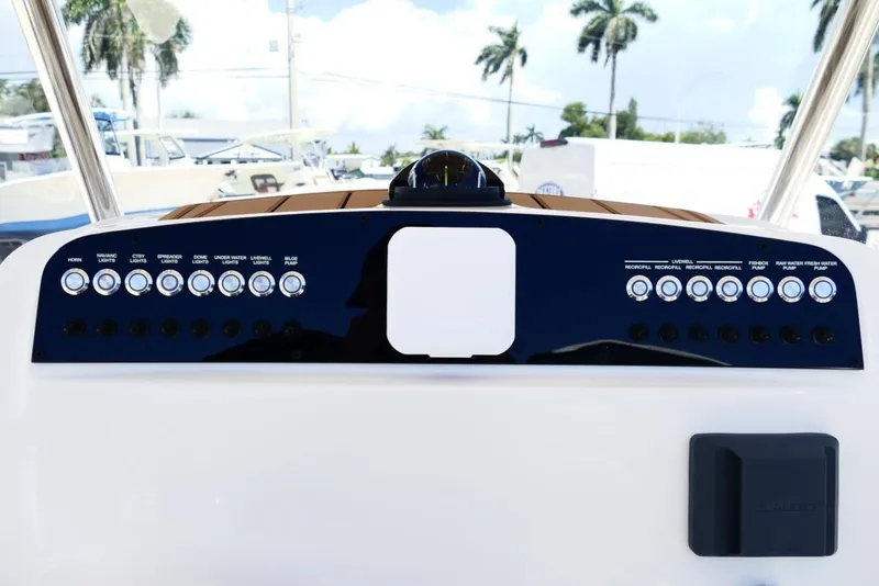Slide: The Image of Control panel of 2026 Pioneer 222 Islander boat with various switches and buttons. - 14