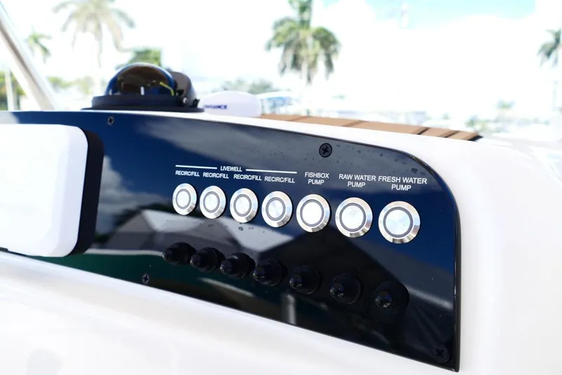 Slide: The Image of Control panel of 2026 Pioneer 222 Islander boat with pump switches and labels. - 16