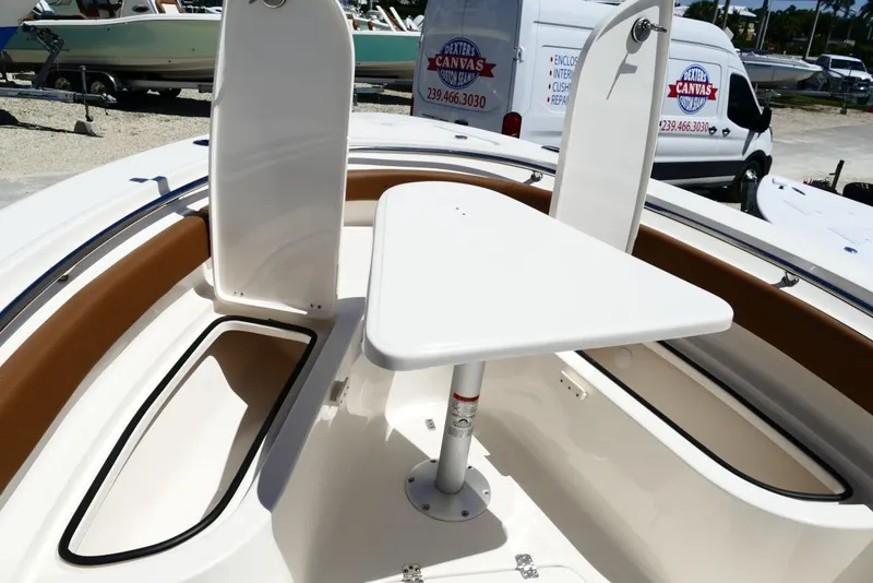 Slide: The Image of 2026 Pioneer 222 Islander boat interior with table and storage compartments. - 24
