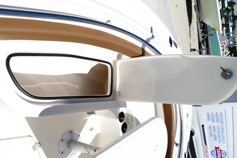 Slide: The Image of 2026 Pioneer 222 Islander boat storage compartment with open hatch, showcasing interior space. - 25